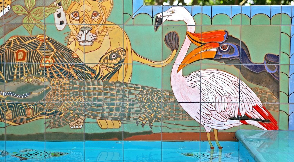 Detail: the right-hand panel, with a lioness, a tortoise, a crocodile along the waterline, a flamingo and a hornbill.