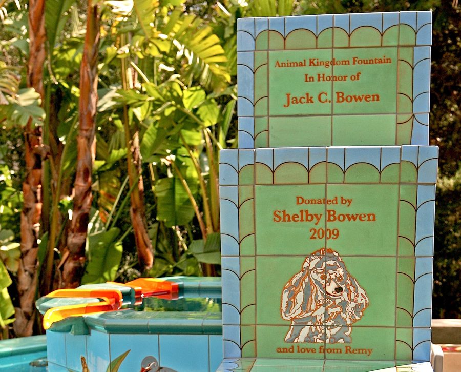 The dedication tiles: Animal Kingdom Fountain, in honor of Jack C. Bowen; donated by Shelby Bowen, 2009, with a small curly-coated dog and the words 'and love from' beneath.