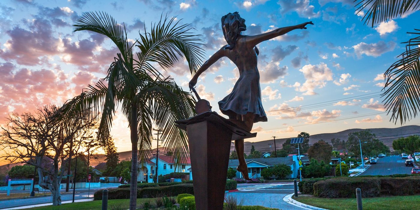 Stepping Out, the bronze dancer at Ventura College, against a sunset sky.