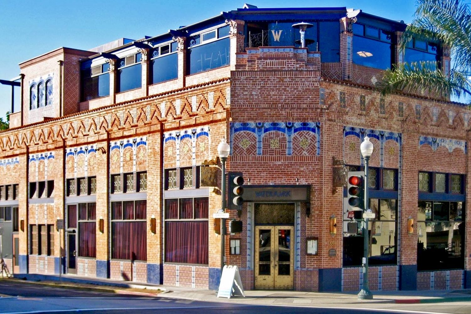 The Watermark building: 1920s red brick with bands of blue, gold and red tile and a new top floor.