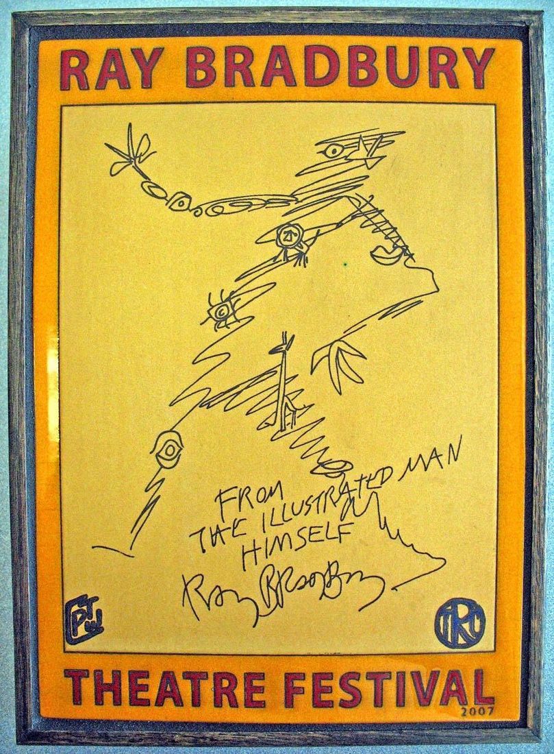 A yellow ceramic plaque reading Ray Bradbury Theatre Festival, with Bradbury's own line drawing of the Illustrated Man and his signature.
