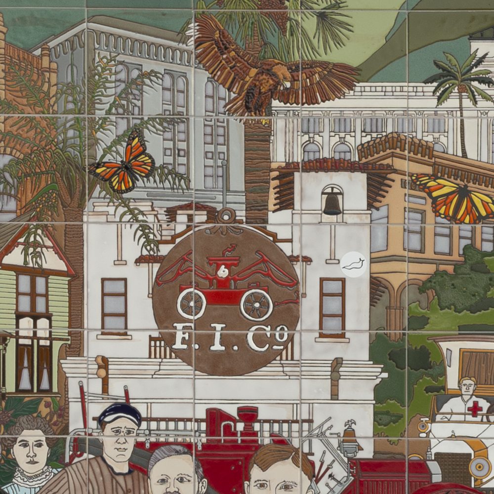 Detail: the old firehouse with the F.I.Co. emblem and a red fire engine, beneath monarch butterflies.