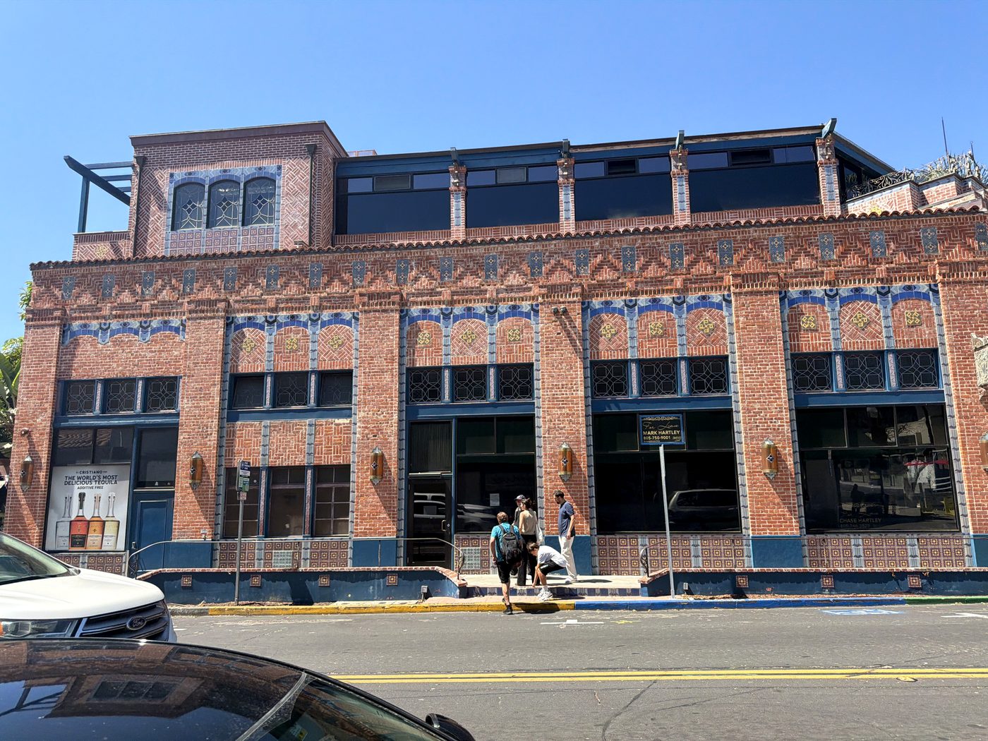 The Watermark building along Main Street, with tile arches over every window and the new top floor above.
